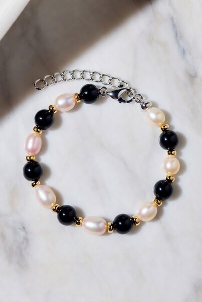Black onyx and freshwater pearl bracelet with gold bead spacers
