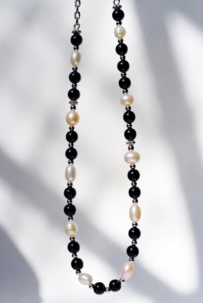 Black onyx and freshwater pearl eyeglass lanyard on stainless steel chain